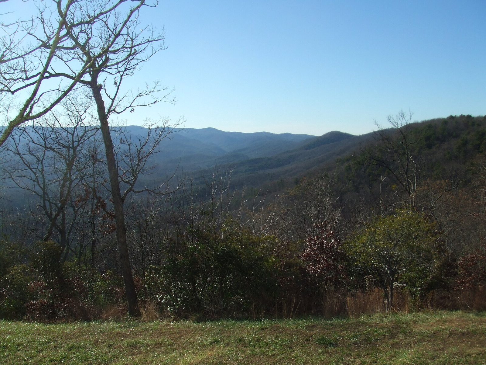 The view from the Amicalola Falls State Park lodge over a mown lawn to rolling blue ridges under a clear winter sky